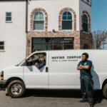 Moving company team with van parked outside building, ready for service.